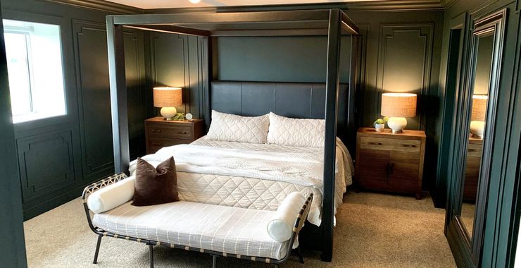 Bedroom with custom floor-to-ceiling wall paneling in deep green